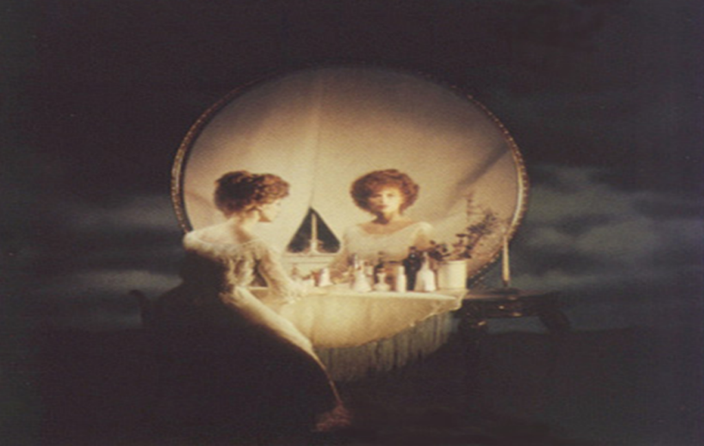 a beautiful lady looking at a mirror or you might be suprised to see someting scary like a skull.